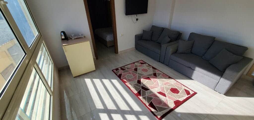 Bright living room with sofa and large windows in Hurghada.
