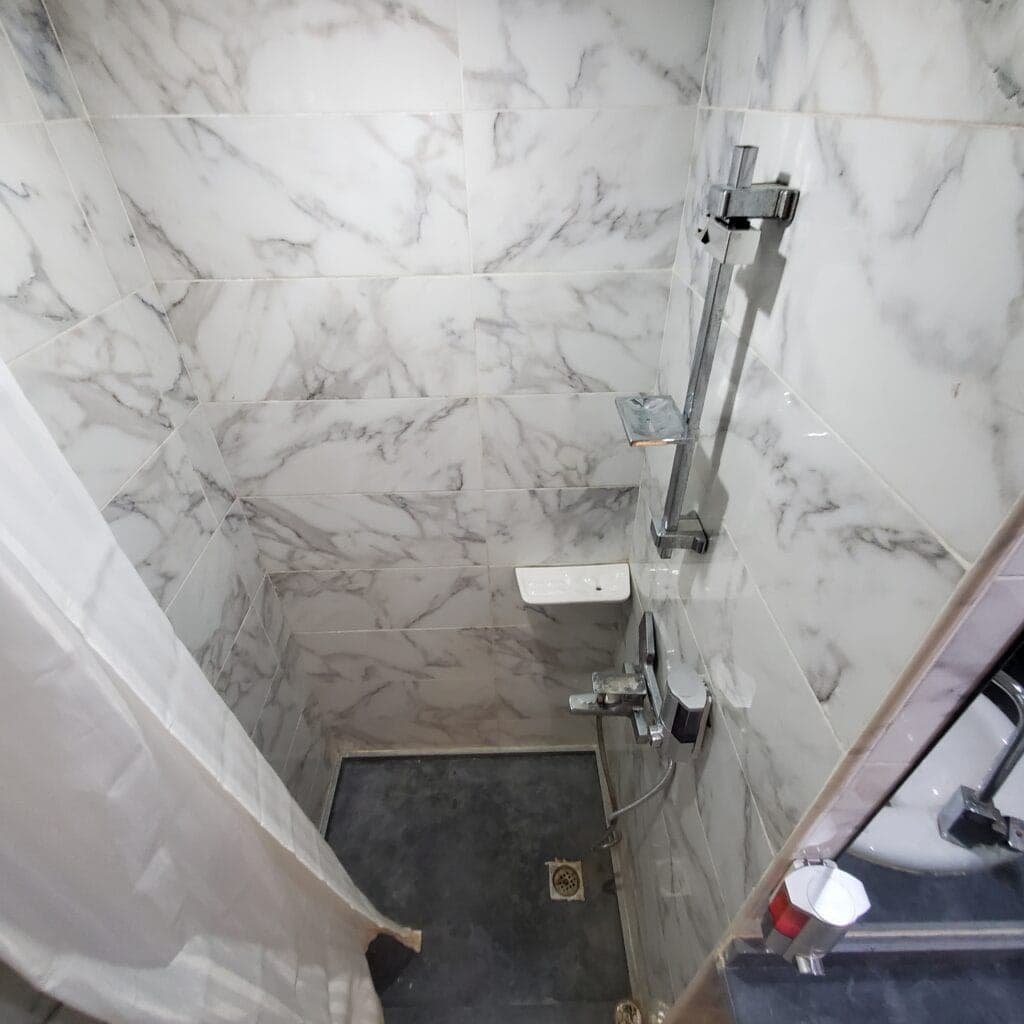 Shower area in a modern studio apartment with pool view and balcony in Hurghada.