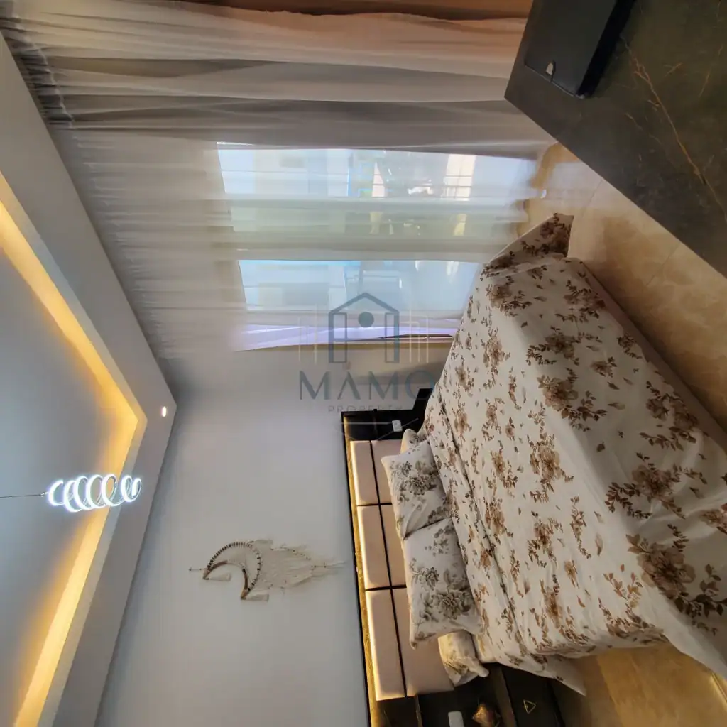 Elegant bedroom with large window and stylish decor in Hurghada holiday rental.