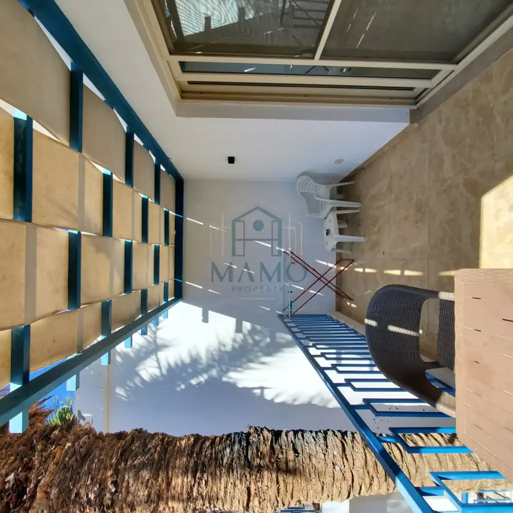 Balcony with outdoor chairs and a view of the sky, perfect for relaxing in the sun.