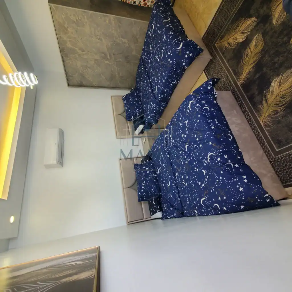 Bedroom with starry night themed bedding and celestial wall art.