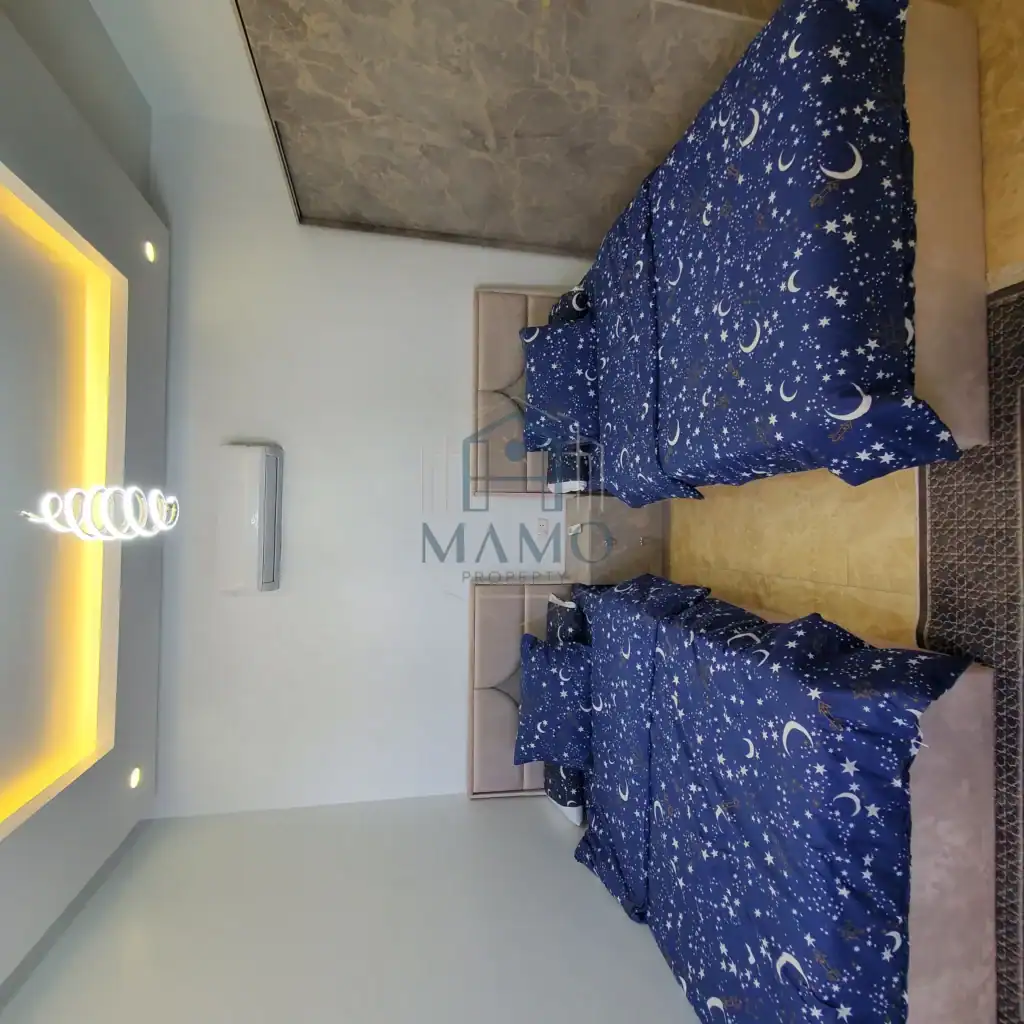 Starry night bedding in a modern Hurghada hotel apartment, ideal for a relaxing vacation.