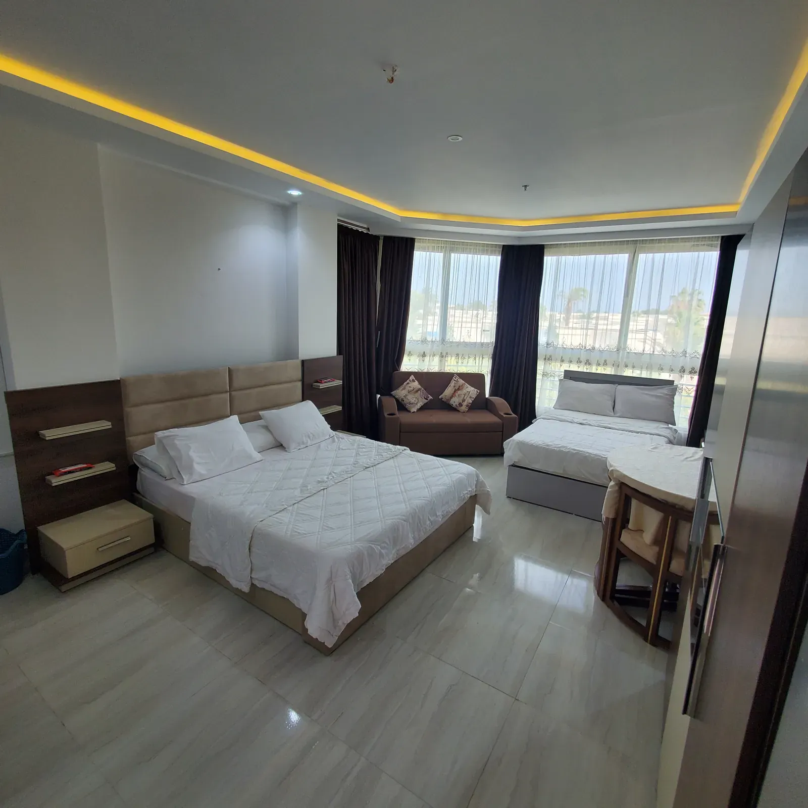 Modern hotel room with two beds and garden view for rent in Hurghada.